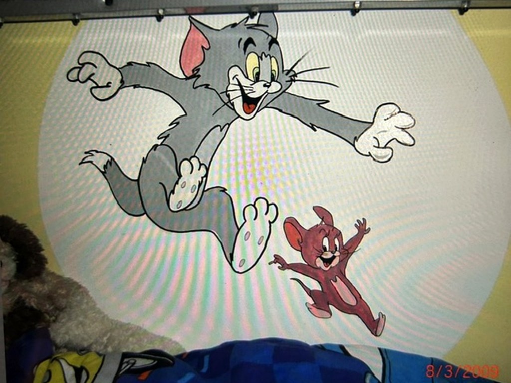 Hand painted Tom and Jerry mural in a child's bedroom