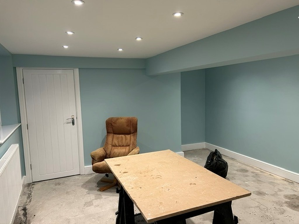 Garden room painted in soft blue with a white ceiling and crisp white woodwork