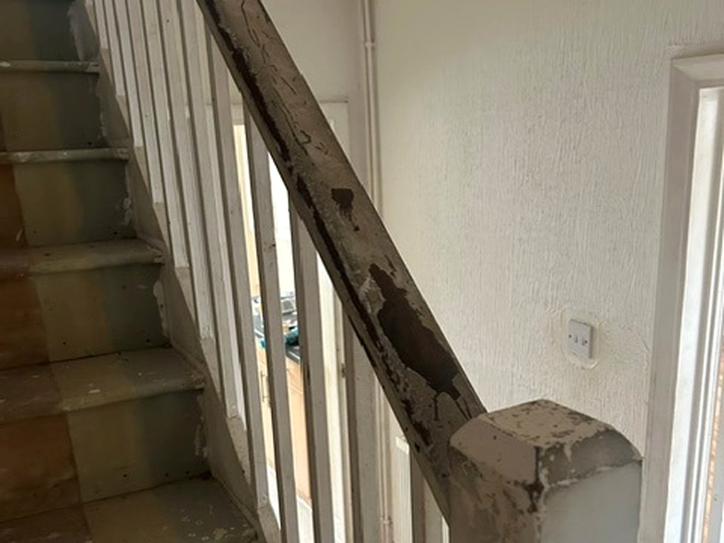 Stripped staircase handrail and newel post ready for filling and priming