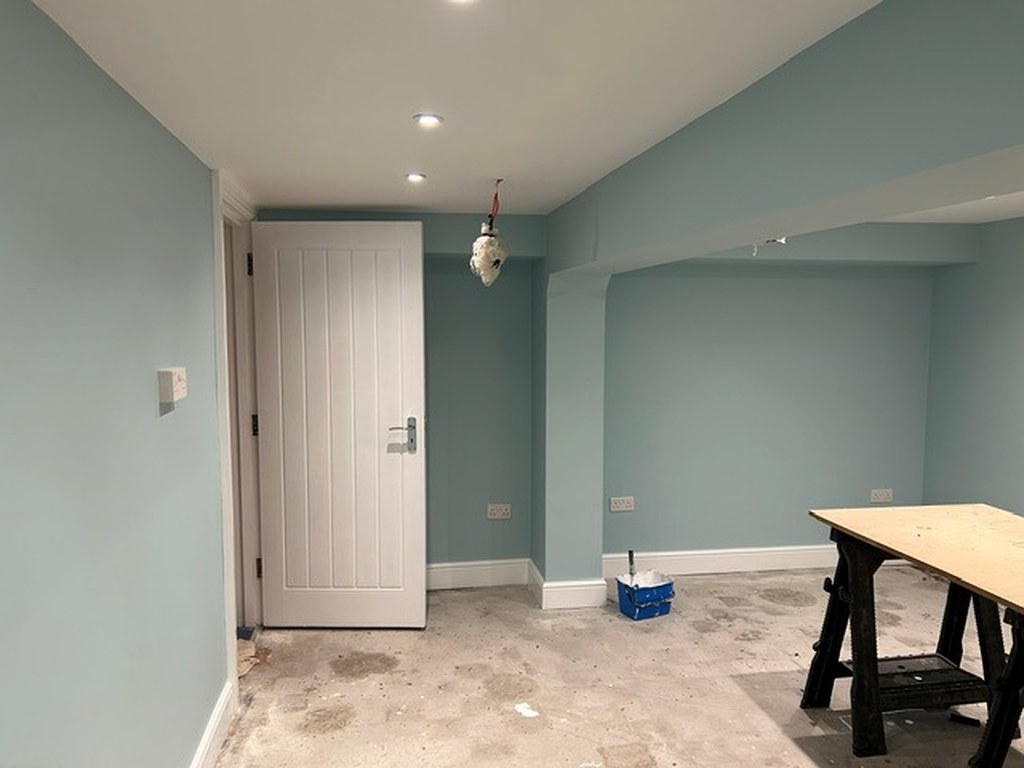 Doorway and alcove painted soft blue with white door, frame and skirting