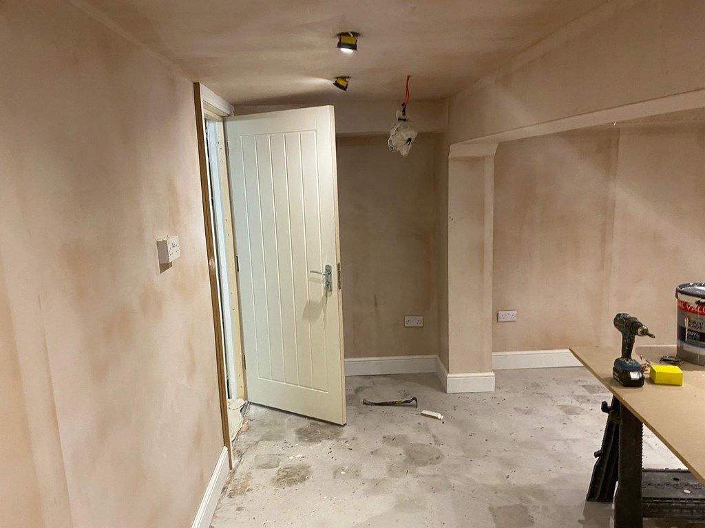 Bare plaster walls around a new doorway and alcove before decorating