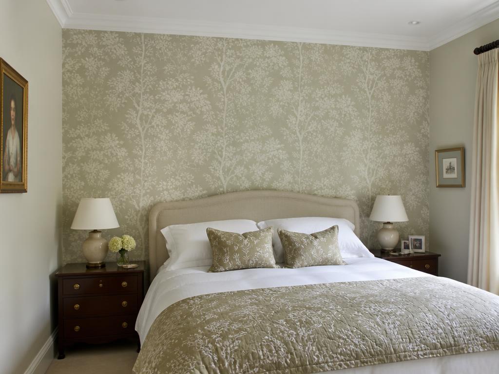 Elegant bedroom feature wall with carefully hung patterned wallpaper